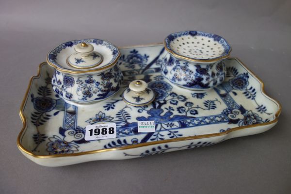 A Meissen porcelain desk stand, late 19th century, decorated with gilt blue flowers and birds, with an inkwell and cendrier, on a rectangular shaped t