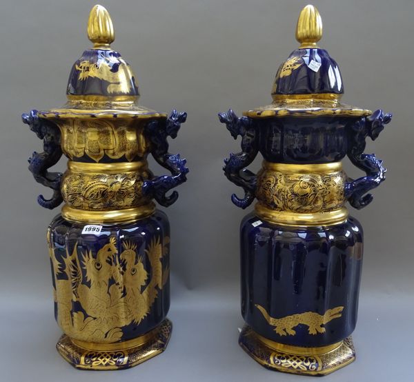 A pair of tall Mason's Ironstone mazarine blue-ground two-handled vases and covers, circa 1820, the ribbed cylindrical bodies and domed covers gilt wi