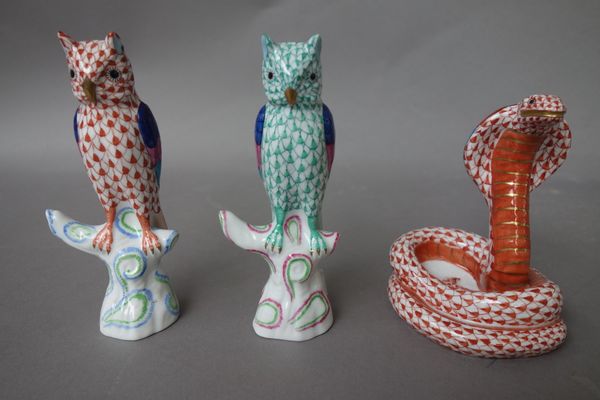 A Herend porcelain cobra, Imari decorated gilt and red; and two Herend porcelain owls, each Imari decorated, modelled on a tree stump, five Herend mat