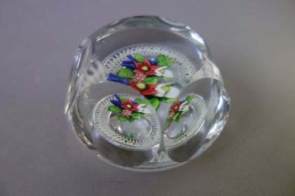 A St Louis facet cut paperweight, mid-19th century, set with a bouquet of flowers inside a white torsade, (a.f), 8cm. diameter.