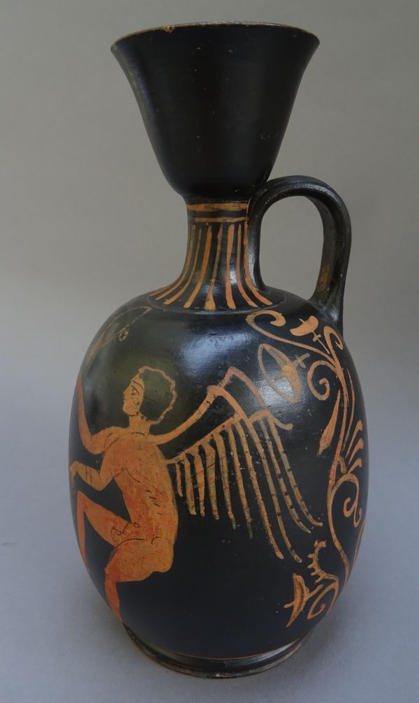 A Paestan red-figured squat Lekythos, attributed to the Asteas-Pythos Workshop, circa late 4th century B.C., decorated with a woman seated offering a