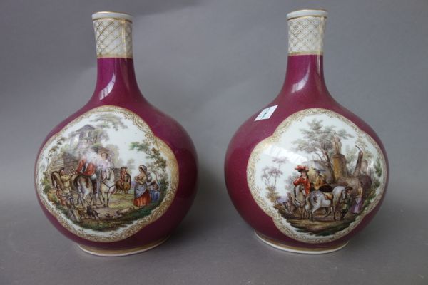 A pair of German porcelain bottle vases, early 20th century, each decorated with figures in a landscape against a gilt puce ground, mark to base, 20cm