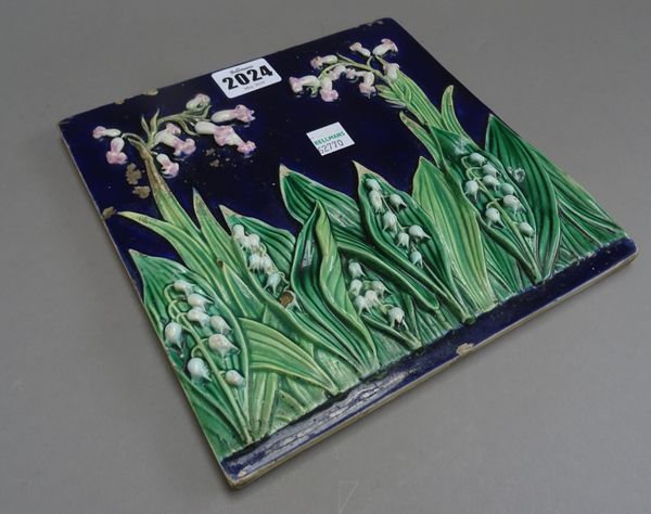 A George Jones majolica tile, circa 1870, moulded with lily of the valley against a cobalt blue ground, black painted number 1890/12, 19.75cm.