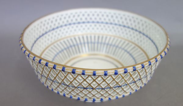 A Vienna porcelain circular bowl, late 18th century, the sides pierced with basketwork picked out in blue and gilding, blue painted shield mark, 20cm.