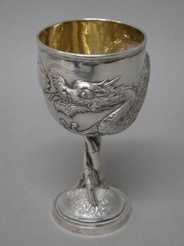 A Chinese silver goblet, the bowl decorated with a dragon, the stem formed as three entwined bamboos and raised on a circular foot, marked TC, height