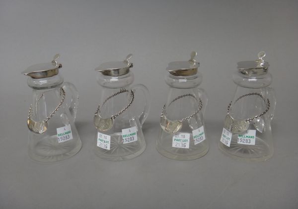 A set of four silver mounted glass whisky noggins, Birmingham 1937, with four silver labels detailed Whisky, one Birmingham 1936, the other three Birm