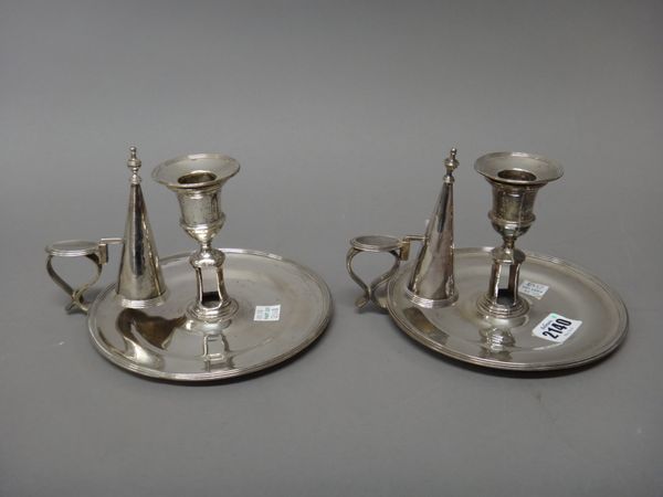 A pair of George III silver chamber candlesticks, each of circular form having a reeded rim and fitted with a sconce and a snuffing cone, maker probab