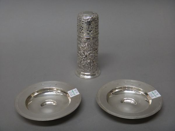 Silver and silver mounted wares, comprising; a sugar caster, with foliate scroll embossed decoration, Chester 1902 and a pair of circular Armada style