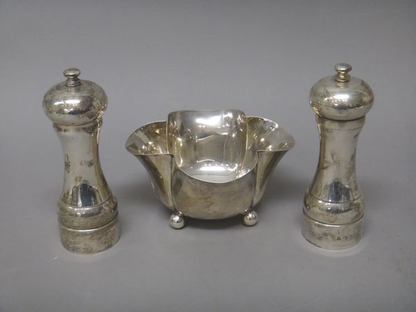 A late Victorian silver bowl, of quatrefoil shaped form, raised on four spherical feet, width 15cm, London 1897 and a pair of silver mounted peppermil