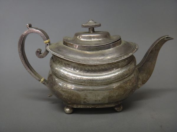 A George III silver teapot, of curved boat shaped form, with engraved decoration and raised on four bun feet, London 1812, gross weight 636 gms.   Ill