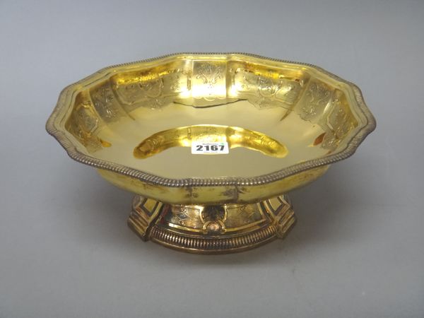 A French silver gilt shaped circular bowl, late 19th century, chased in the 18th century style, with scrolls and foliage on a matted ground, within a