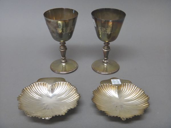 Silver, comprising; two wine goblets, both initial engraved, Birmingham 1971 and two late Victorian butter shells, each raised on three spherical feet