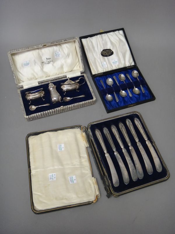 A silver three piece condiment set, Birmingham 1933, with two various silver condiment spoons, cased, a set of six coffee spoons, Birmingham 1927, cas