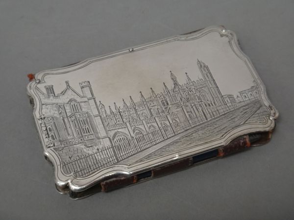 A Victorian silver mounted shaped rectangular aide memoire, the back and the front engraved with views possibly of Emmanuel College to one side and of