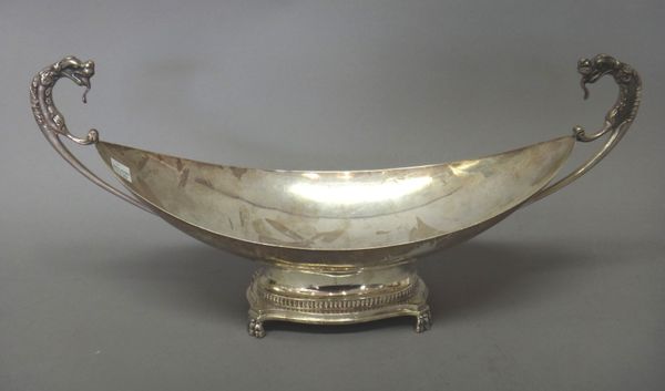 A Continental two handled boat shaped bowl, of shallow classical form, the handles terminating as mythological animals, the curved rectangular foot ra