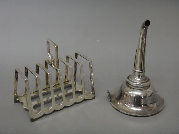 A late Victorian silver seven bar toastrack, of angular form, with a loop shaped handle, Sheffield 1897, weight 250 gms and a plated wine funnel, gilt