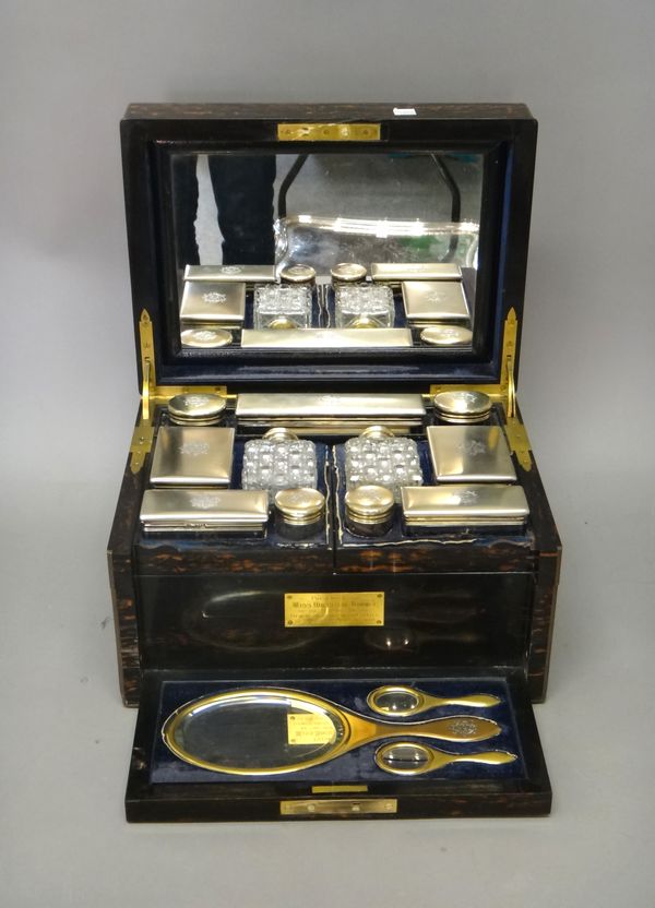 A Victorian silver gilt and gilt base metal mounted, coromandel wood travelling dressing/toilet case, fitted with a mirror within the lid, the rectang