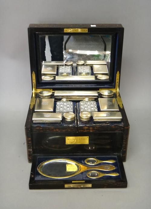 A Victorian silver gilt and gilt base metal mounted, coromandel wood travelling dressing/toilet case, fitted with a mirror within the lid, the rectang