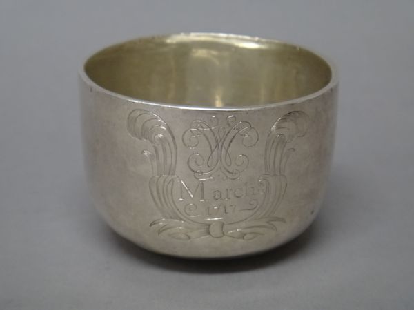 An early George I Britannia Standard silver tumbler cup, engraved with an 18th century cypher and detailed March 15th 1717, within a feathered scrolli