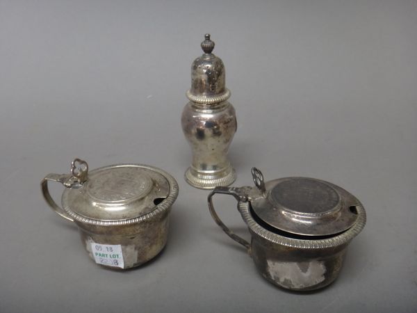 A silver mustard pot, the hinged lid mounted with a Portuguese coin, London 1899, another silver mustard pot, the hinged lid mounted with a differing