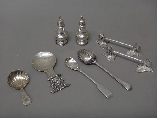 Silver, comprising; a George III tea caddy spoon, having a shell shaped bowl, the handle with bright cut engraved decoration, probably London 1792, a