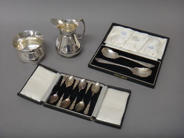 Silver, comprising; a set of six coffee spoons, with cast decoration to the handles, Birmingham 1958, with a case, two similar preserve spoons with sc