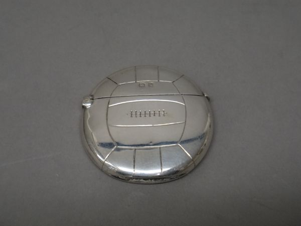 A silver vesta case, designed as a football, detailed George Maurice & Co, Birmingham 1907, maker possibly J.H Hillcox, gross weight 23 gms.   Illustr