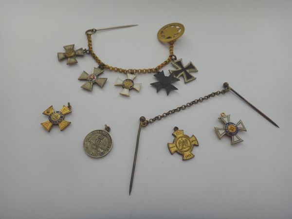 Nine mostly Imperial German dress miniature awards and medals, including an iron cross, comprising five mounted to a chain, having a pin and a button