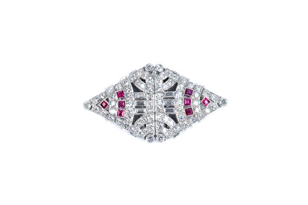 A diamond and ruby set double clip brooch, in a pieced geometric design mounted with baguette and circular cut diamonds and with two groups of four sq