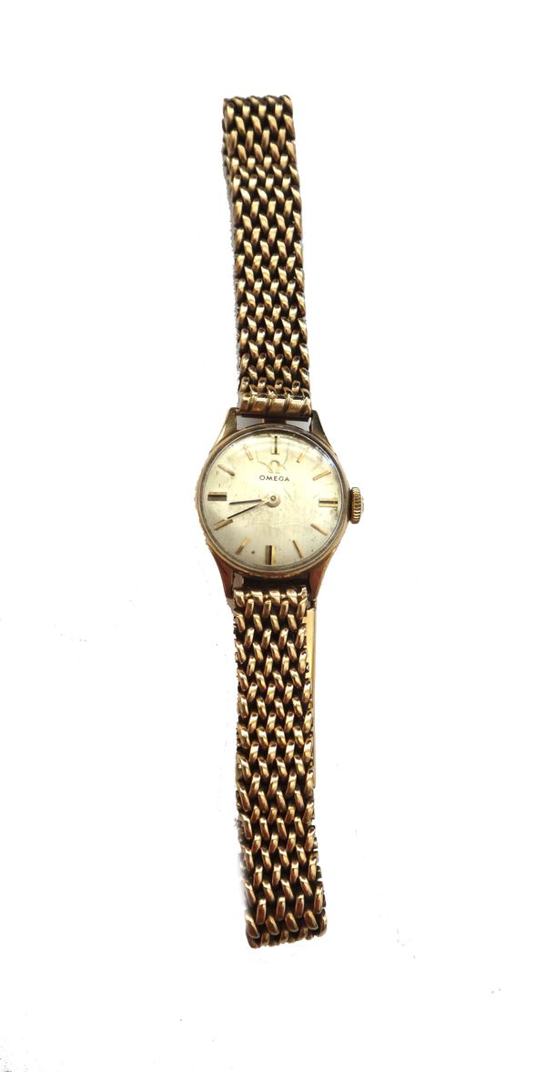 An Omega 9ct gold circular cased lady's wristwatch, with a signed jewelled movement, the signed silvered dial with baton shaped numerals, the case pro