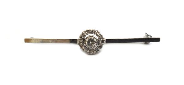 A diamond cluster bar brooch, collet set with the principle circular cut diamond at the centre, in a surround of smaller circular cut diamonds, detail