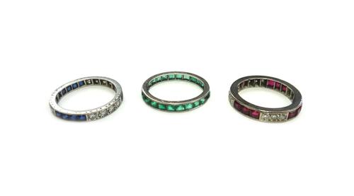 A ruby and diamond set full eternity ring, mounted with four rows of three square cut rubies, alternating with four rows of three circular cut diamond