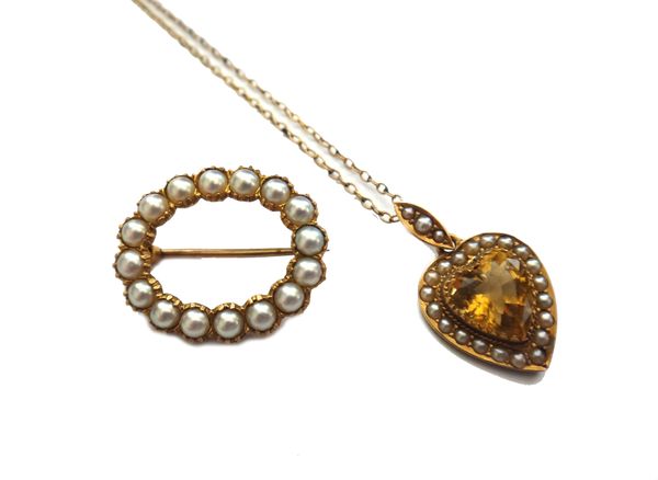 A gold, citrine and seed pearl set heart shaped pendant, mounted with a heart shaped citrine at the centre, within a surround of seed pearls and with