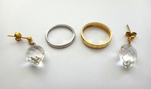 An 18ct gold faceted wedding ring, weight 4 gms, a platinum decorated wedding ring, weight 2.8 gms and a pair of colourless gem set pendant earrings,