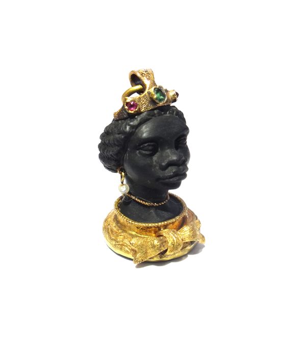 A gold mounted and gem set pendant, designed as the head of a blackamoor, wearing seed pearl pendant earrings and with a bow at the front, with a late