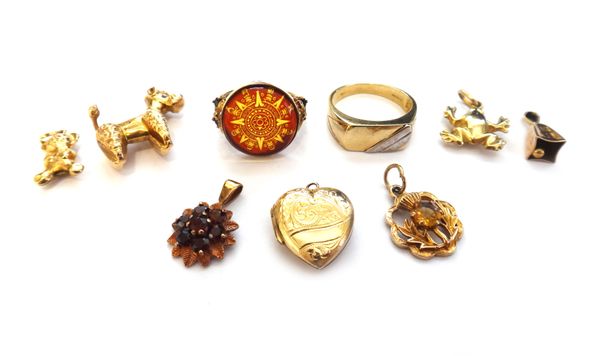 Two 9ct gold rings, a garnet set cluster pendant, a gold back and front heart shaped pendant locket and five mostly 9ct gold charms, including; a gem