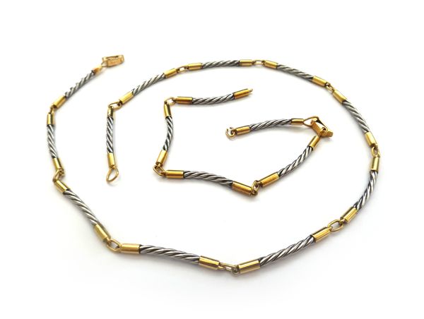 A gold bi-coloured necklace and bracelet, each in a curved baton shaped link design, with a folding clasp, detailed Gregory 18 K, with a box, (2).