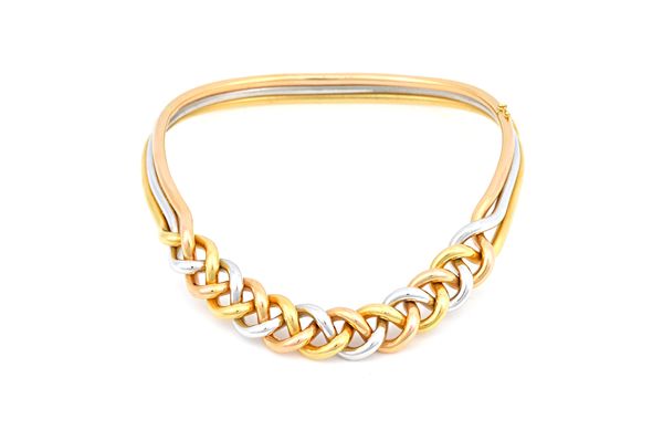 A three colour gold demi parure, comprising; a collar necklace, an oval hinged bangle and a pair of trefoil shaped earclips, the collar necklace and t