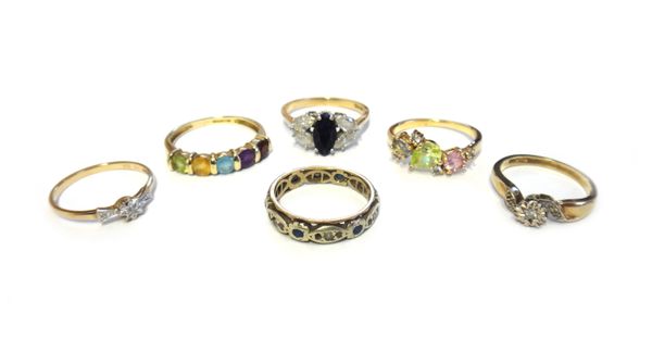 A 9ct gold and diamond set ring, in a twistover design, a 9ct gold and diamond set single stone ring, two 9ct gold and gem set rings and two further r