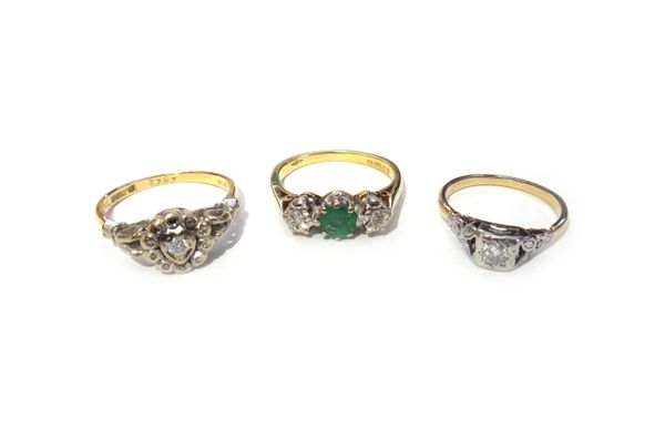 A gold ring, mounted with a circular cut diamond within a square shaped setting between foliate shaped shoulders, an 18ct gold, emerald and diamond se