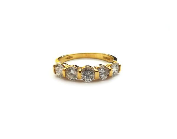 An 18ct gold and diamond five stone ring, mounted with a row of circular cut diamonds, the diamonds weigh approx total 1.15 cts, ring size M, with a c