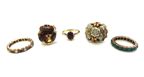 A gold ring, claw set with a circular cut smoky quartz, a gold and colourless gem set ring, detailed 750, a gold and garnet single stone ring, a gold