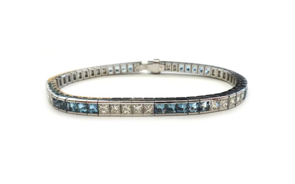 An 18ct white gold, aquamarine and diamond bracelet, 2004, channel set with rows of five princess cut diamonds, alternating with rows of five square c