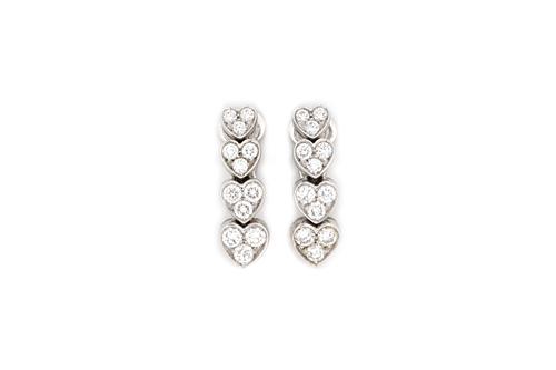 A pair of 18ct white gold and diamond set earclips, 2004, each formed as a row of four graduated diamond three stone heart shaped motifs, mounted with