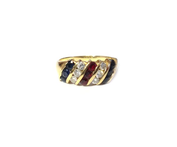 An 18ct gold, diamond, ruby and sapphire set ring, mounted with a row of three circular cut rubies to the centre, between two rows of three circular c