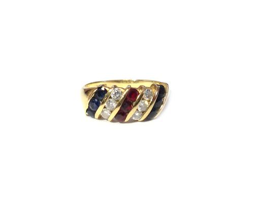 An 18ct gold, diamond, ruby and sapphire set ring, mounted with a row of three circular cut rubies to the centre, between two rows of three circular c