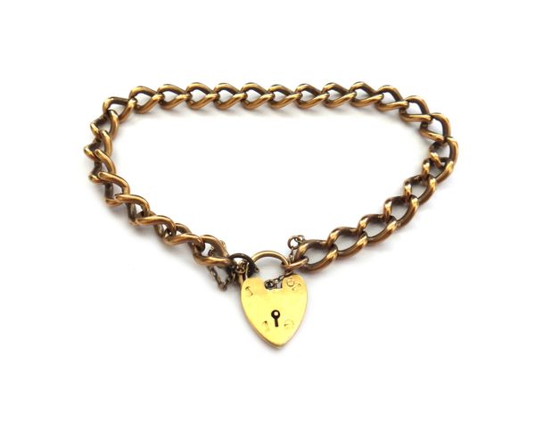 A 9ct gold curb link bracelet, with an 18ct gold heart shaped padlock clasp, fitted with a safety chain, combined weight 27.4gms.