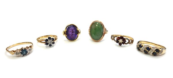 A gold ring, mounted with an oval cabochon jade, detailed 14 K, a gold ring, mounted with an oval cut amethyst, detailed 585, a 9ct gold, sapphire and