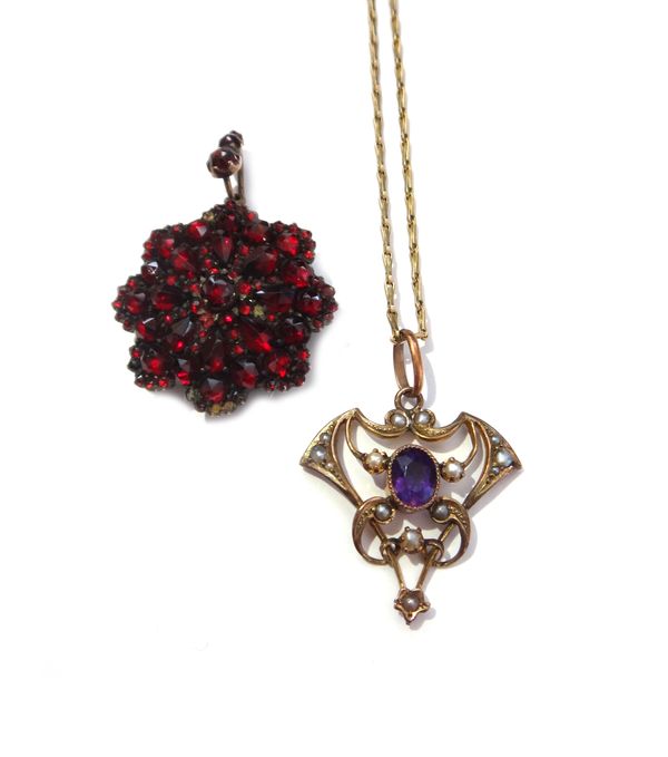 A Bohemian garnet set shaped circular pendant locket, circa 1900, glazed with a locket compartment at the back and a gold, amethyst and seed pearl set