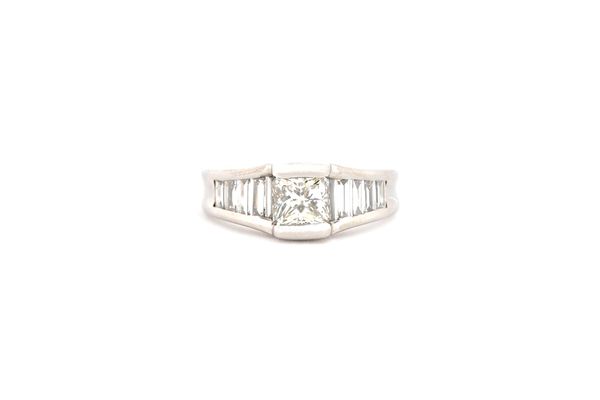 A diamond ring, mounted with the principal princess cut diamond to the centre, between tapered baguette diamond set five stone shoulders, ring size H.